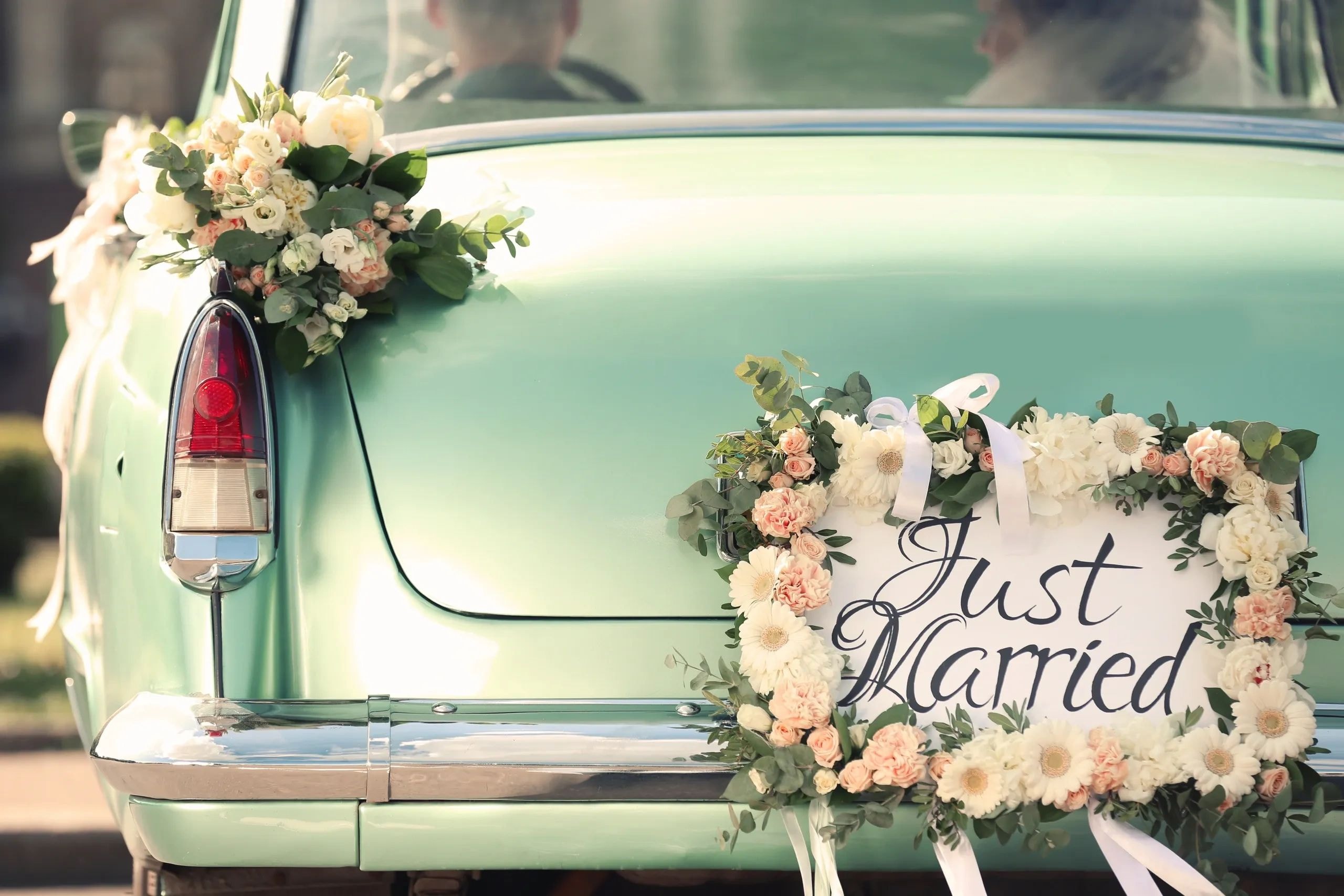 Just married vintage car decorated with flowers